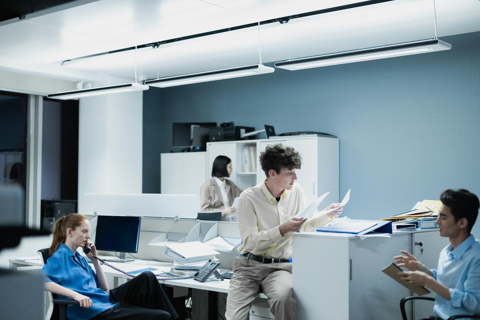 Healthcare administrative team coordinating patient calls in a multi-line office